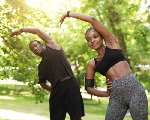 Outdoor Training. Athletic Black Couple Doing Sport Exercises Together In Park, Enjoying Healthy Lifestyle, Free Space